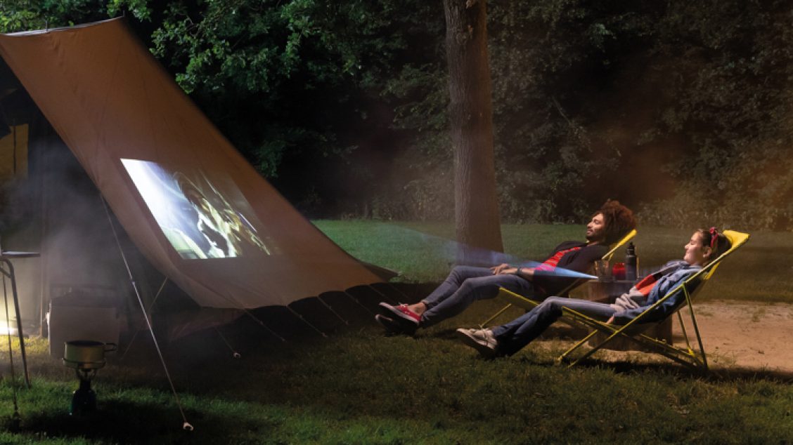 2 mensen kijken een film op de camping
